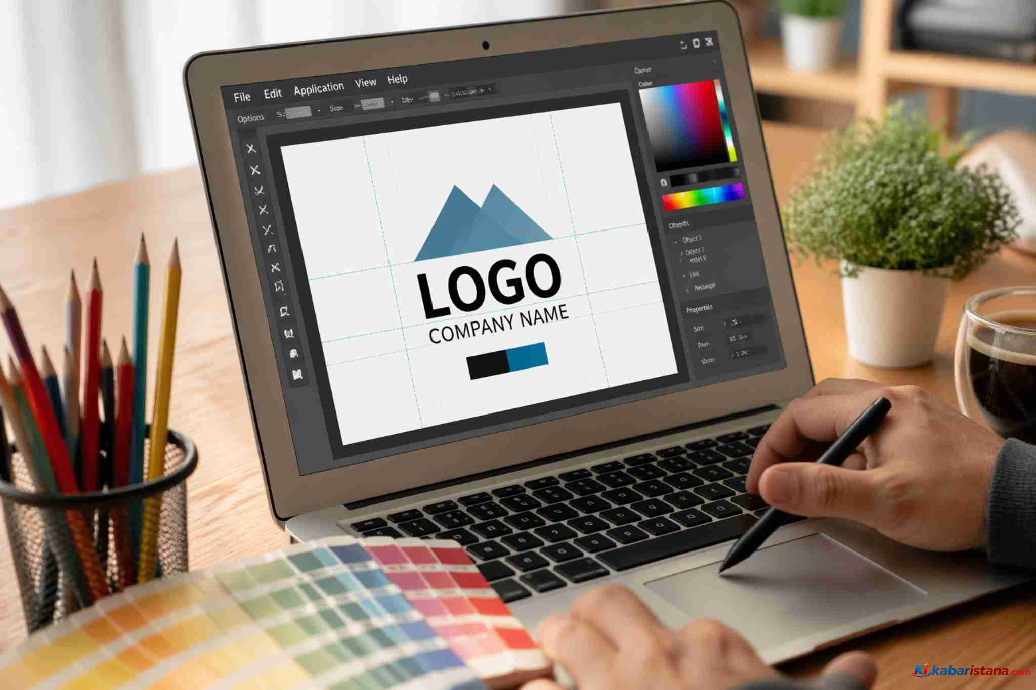 Desain logo dengan tulisan 'LOGO' di layar laptop, dengan latar belakang pensil warna dan palet warna, menggambarkan proses kreatif di ruang kerja.